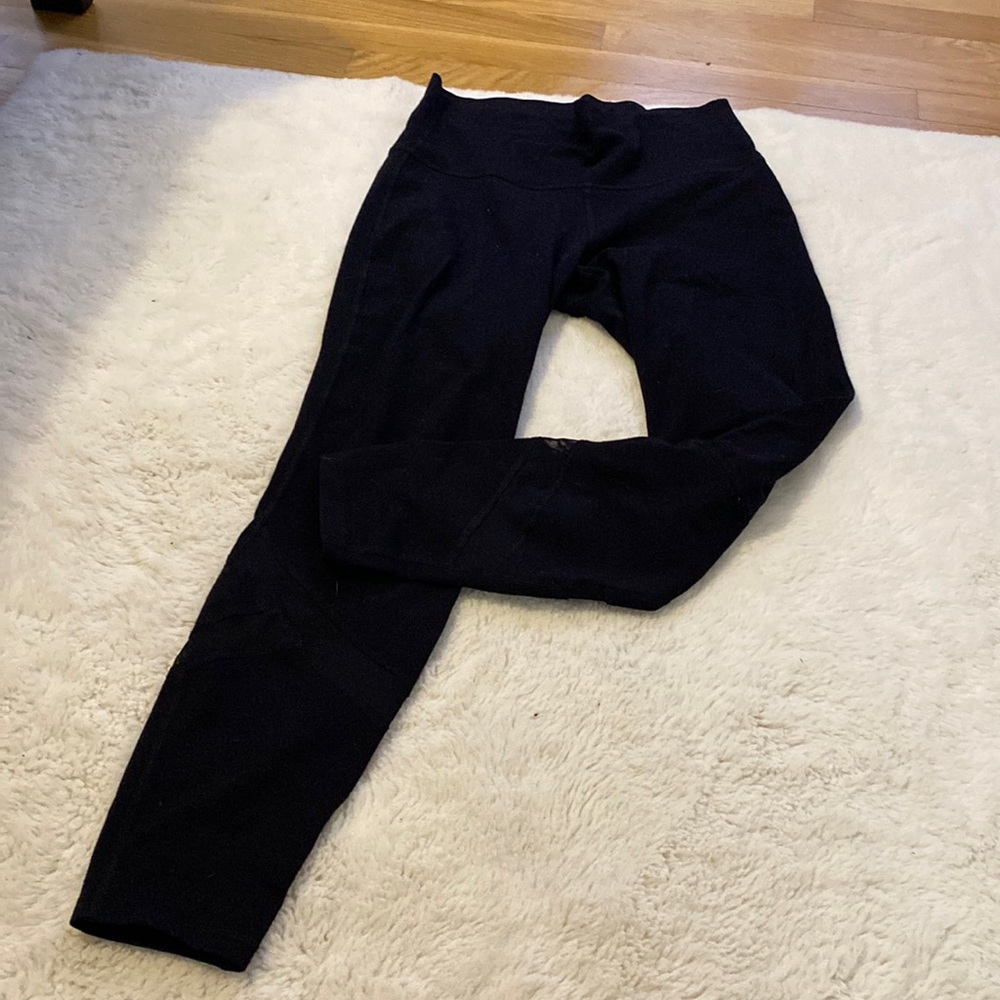 Medium high rise, black leggings with mesh detail on bottom of legs.